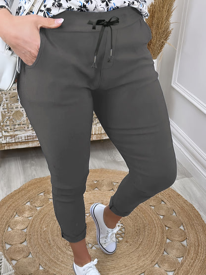 Women's comfortable jogger pants made of stretchy polyester with a drawstring waist, solid color, and machine washable for all-season wear.