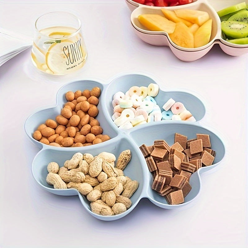 Heart-shaped party snack tray with 4 compartments, perfect for serving nuts, candy, fruit, and other snacks. Made of reusable plastic in blue, green, beige, and pink colors.