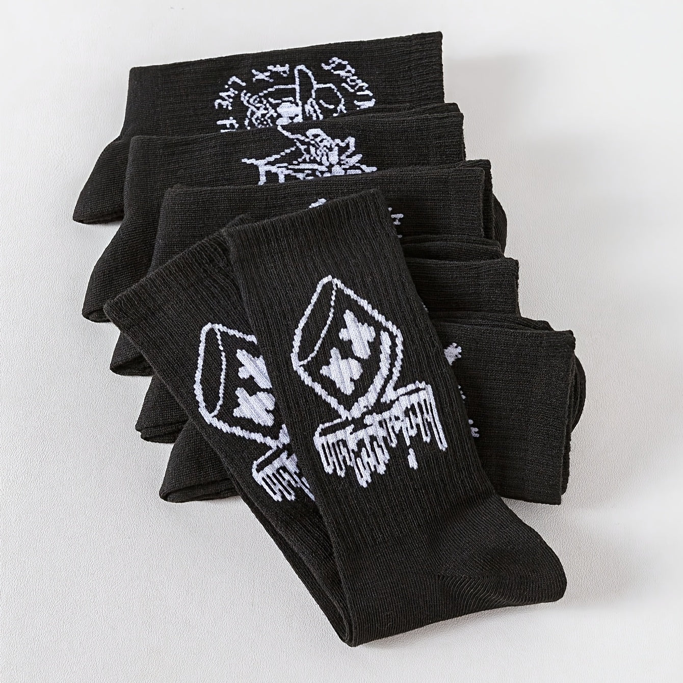 6/10 pairs of men's mid-calf socks with random black and white graffiti designs for all seasons.