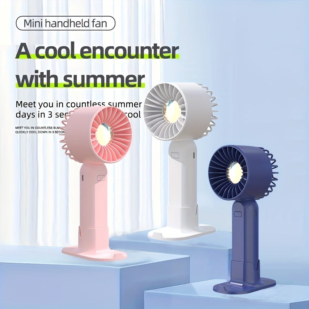 Mini fan with multiple functions - serves as a base and mobile phone holder, features three adjustable wind speeds and can be charged via USB. Perfect for use in the office, outdoors, or while traveling. Handheld and portable design.