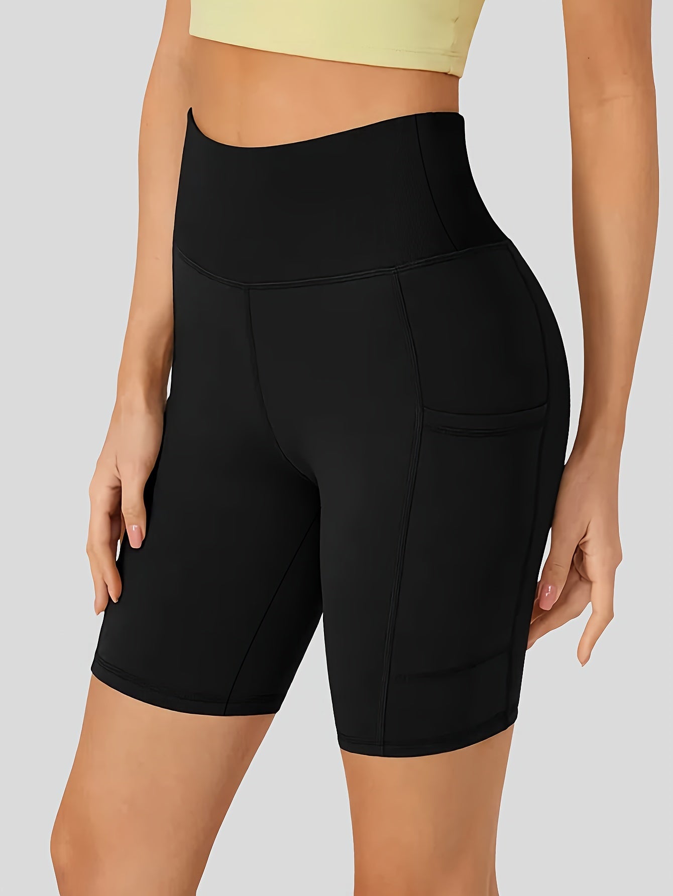 High-waist cycling shorts for women with side pockets, breathable and comfortable, perfect for fitness and outdoor activities.