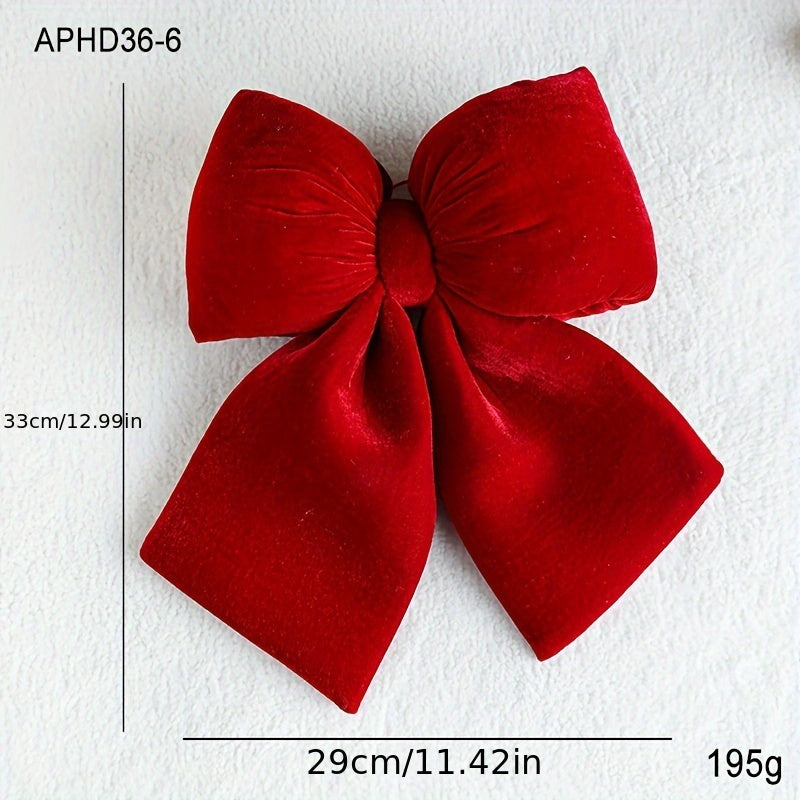 Christmas decorations include a handrail bow, fireplace bow, large velvet ornament bow, and red tree bow.