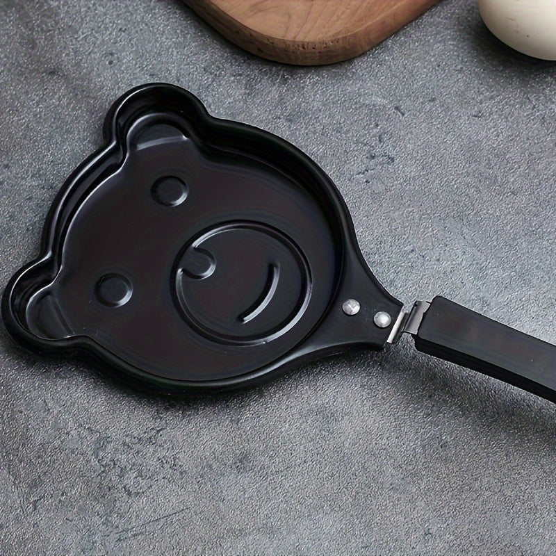 Bear-shaped omelet pan made of cast iron, with non-stick coating and a sturdy handle. This breakfast cookware is dishwasher safe and also doubles as a pancake and steak griddle in the kitchen.