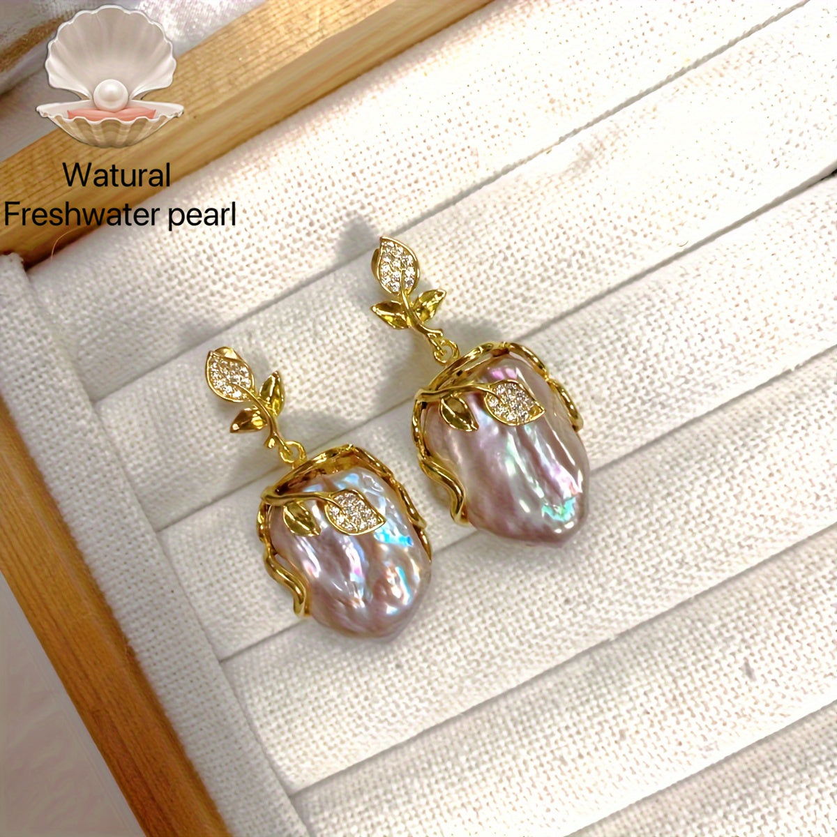 Elegant and luxurious French-inspired freshwater pearl earrings with gold-plated silver leaf accents, perfect for fashion-forward women with a taste for retro style and natural beauty.