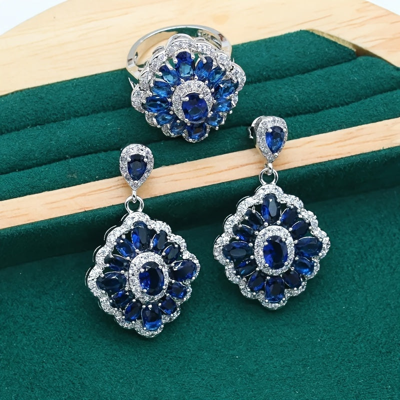 Stunning bridal jewelry set featuring 4 pieces made of luxurious white gold plated copper and adorned with blue cubic zirconia. Set includes a necklace, earrings, and an adjustable ring, ideal for weddings and special events.