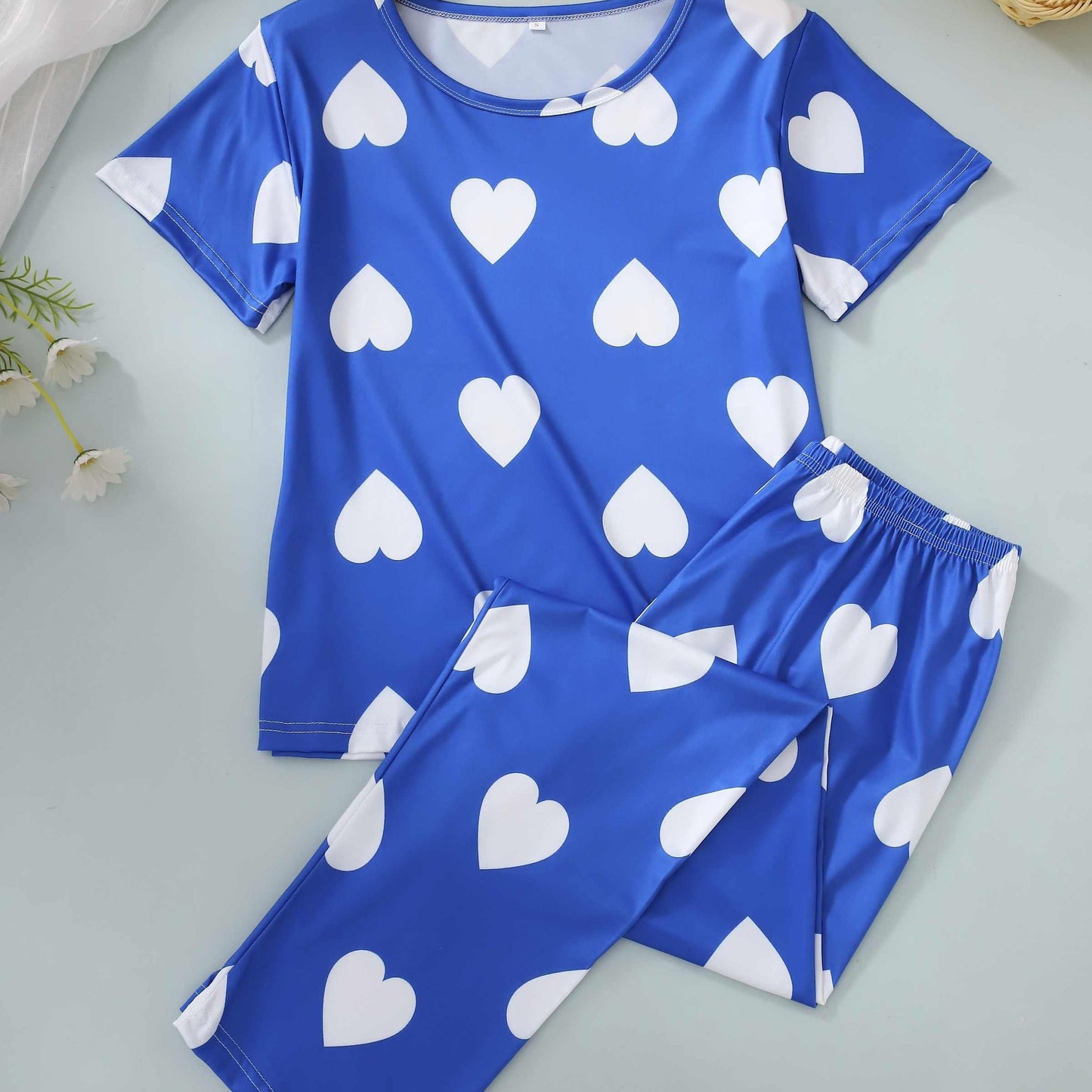 Two-piece pajama set with short-sleeved top and long pants in print.