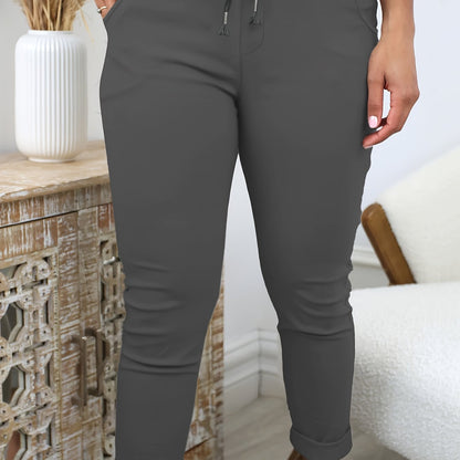 Women's comfortable jogger pants made of stretchy polyester with a drawstring waist, solid color, and machine washable for all-season wear.