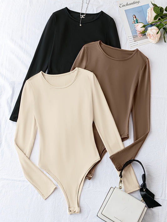 Pack of three solid crew neck long sleeve bodysuits for women. Casual one-piece clothing.