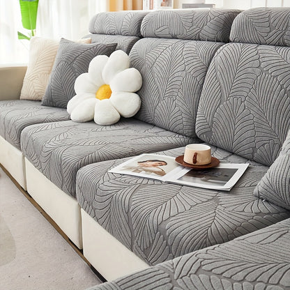 Stylish leaf-patterned sofa cover fits single to four-seater sofas in various colors. Durable jacquard fabric, machine washable.