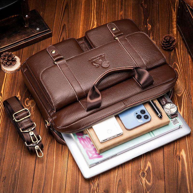 Brown leather briefcase with multiple compartments, adjustable shoulder strap, suitable for travel and professional activities.