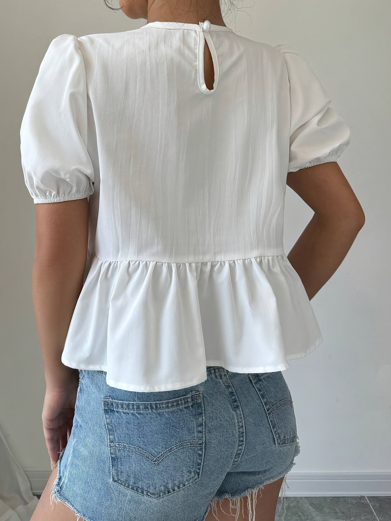 Puff-sleeve shirt with ruffles and front bow tie.