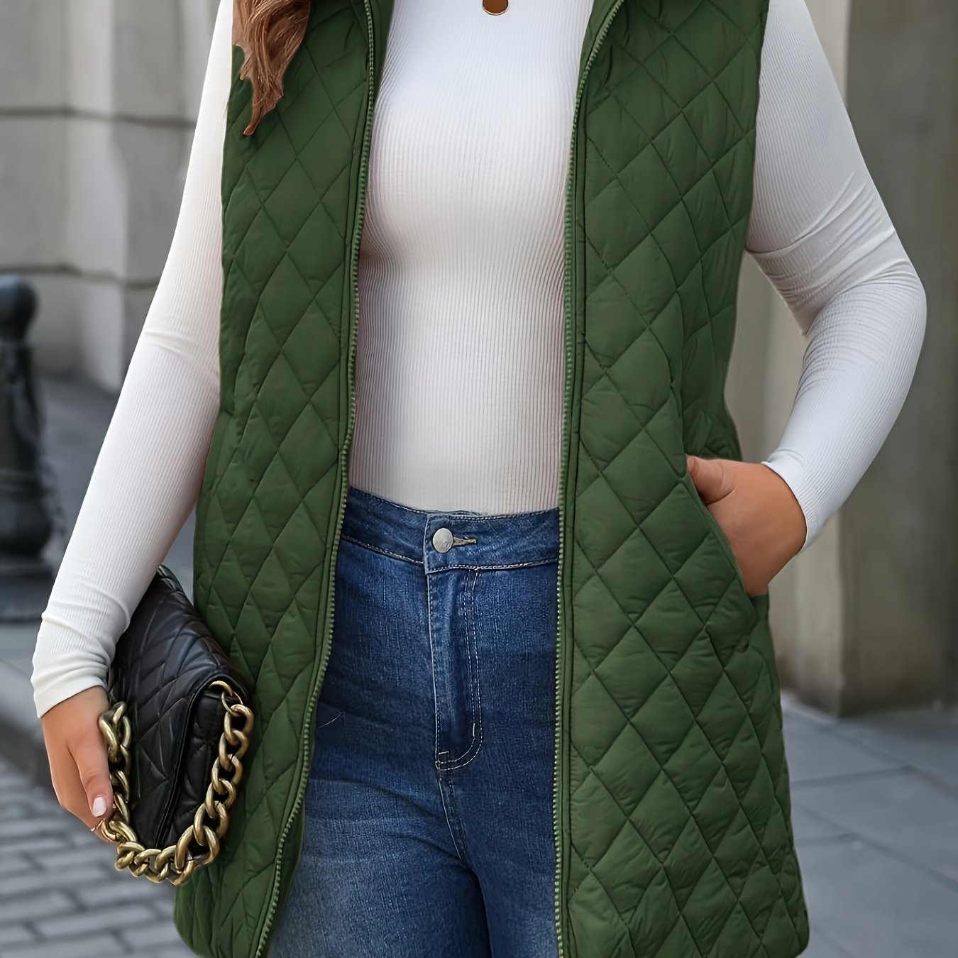 Chic plus-size quilted vest with stand collar and mid-length zip-up closure for winter wear.