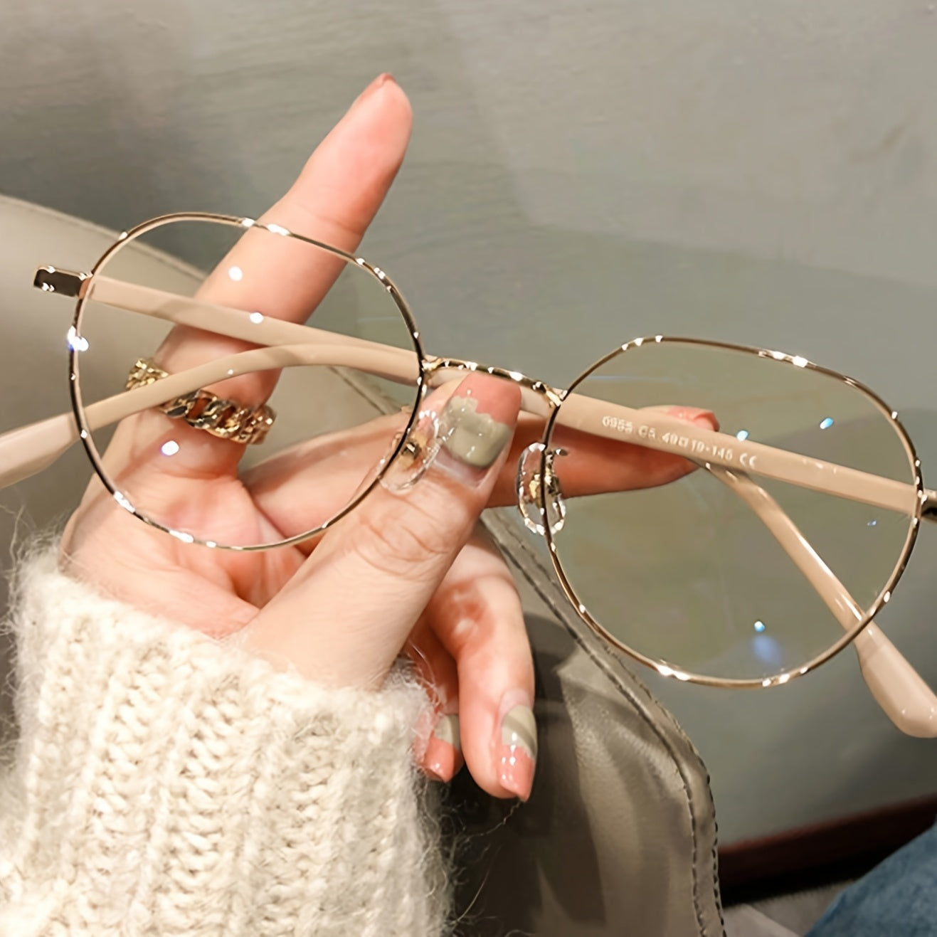 Golden and beige metal round glasses with full-rim design, ideal for reducing blue light exposure while using electronic devices.