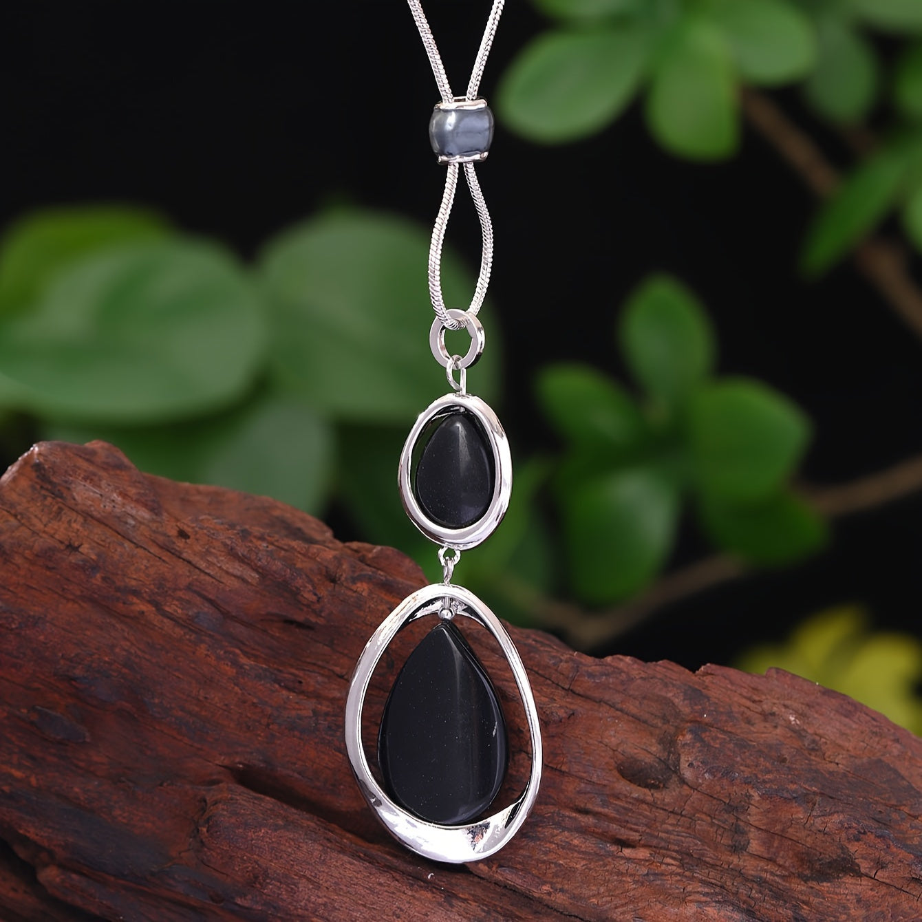 A stylish and sophisticated black stone geometric pendant necklace, perfect for women's accessories. Made from trendy zinc alloy, this long necklace is ideal for daily wear, parties, proms, vacations, and makes a great jewelry gift.