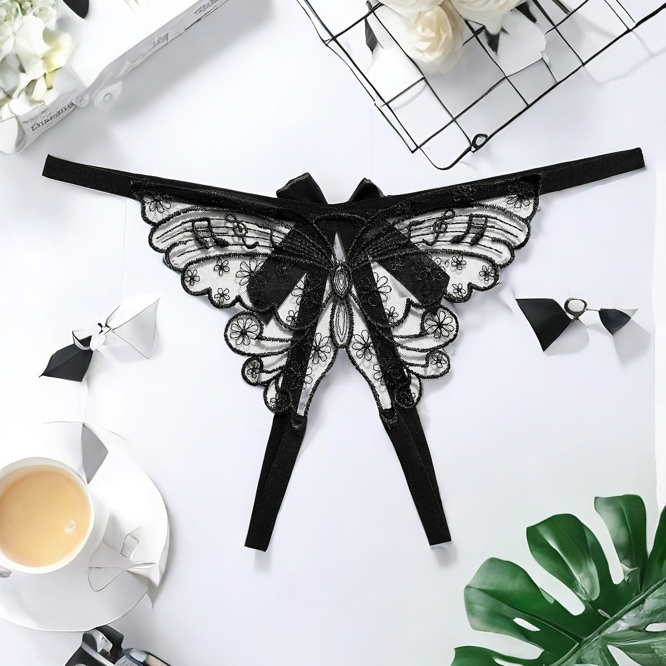 Adults' elegant butterfly embroidery mesh thong with split crotch and bow detail, made of knit fabric.