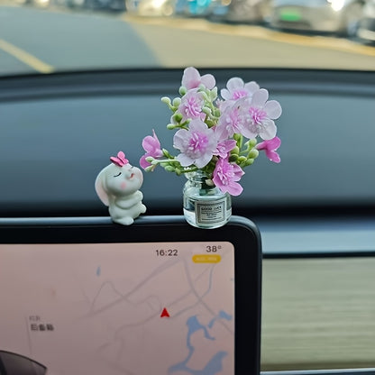 Miniature resin vase for car dashboard décor with healing figurine.