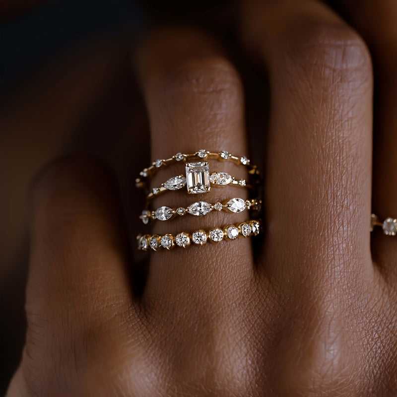 Set of four stunning gold cubic zirconia stacking rings designed for women, offering an elegant and luxurious style. Perfect for engagements, anniversaries, and as a daily or party wear accessory.