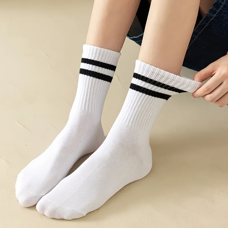 3 pairs of knee-length striped socks for women in black, white, and grey. Made of breathable polyester knit fabric with a casual sport style. Hand wash or dry clean.