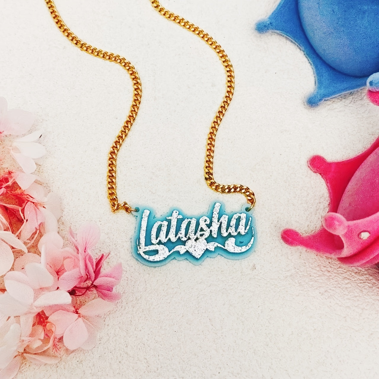 Personalize your style with a custom sparkling acrylic name necklace, adorned with a heart-shaped lace and personalized English nameplate. Available in a variety of colors, this classic piece is perfect for women looking to add a unique touch to their