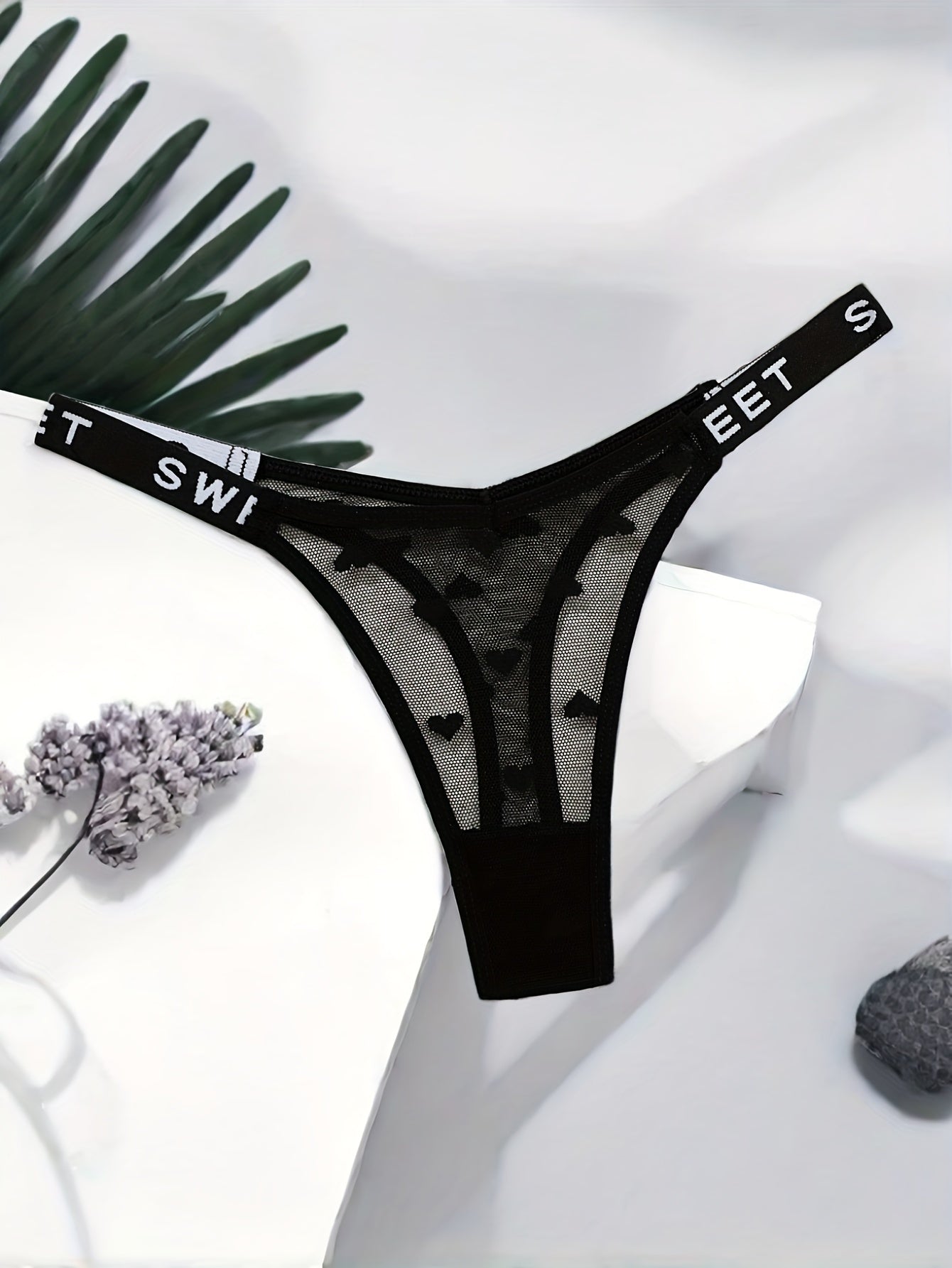 Stylish polyamide blend thong underwear with heart pattern, mesh design, and comfortable stretch fit.