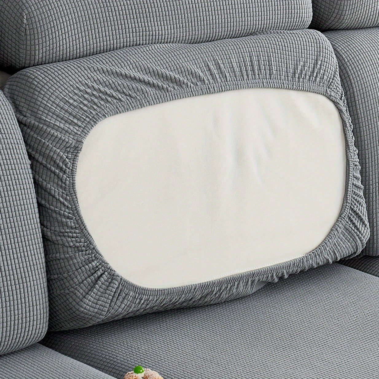 Durable sofa cover protects furniture from spills and stains.