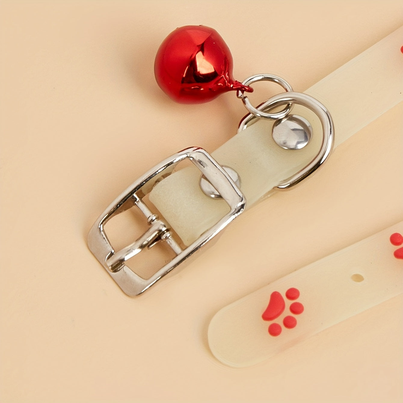 Adjustable glow-in-the-dark cat collar with colorful paw print for easy spotting at night.