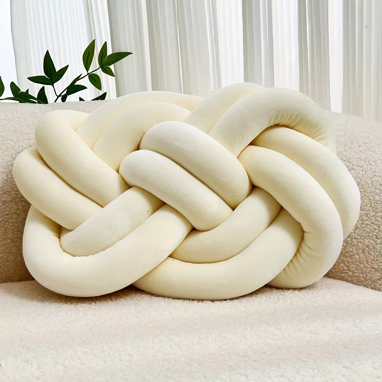 Knotted throw pillow for home decor, suitable for bed or sofa.