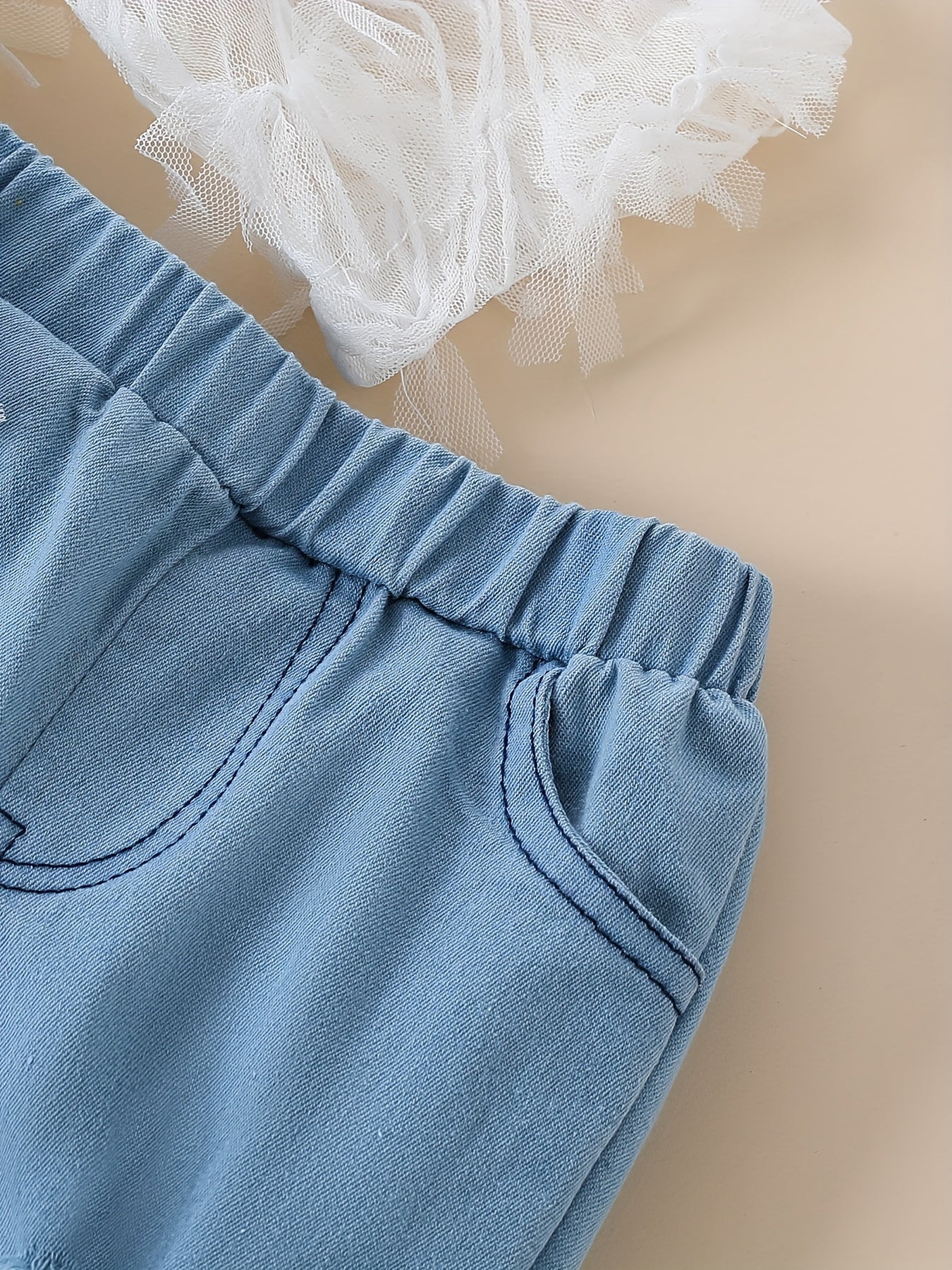 Stylish girls' summer outfit: off-shoulder white lace top with blue tulle flared pants set. Made of 100% polyester, machine washable. Perfect for outdoor wear.