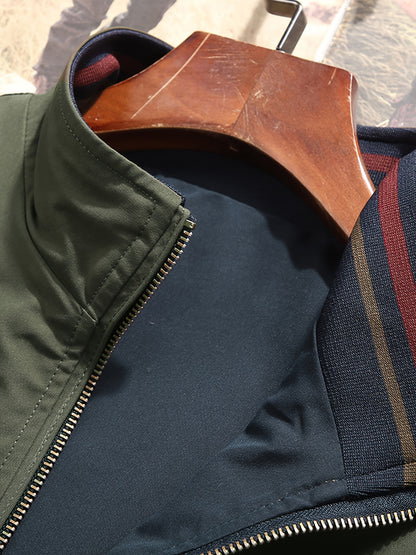 Reversible windproof jacket for men with military-inspired design, zip-up front, pockets, and long sleeves.