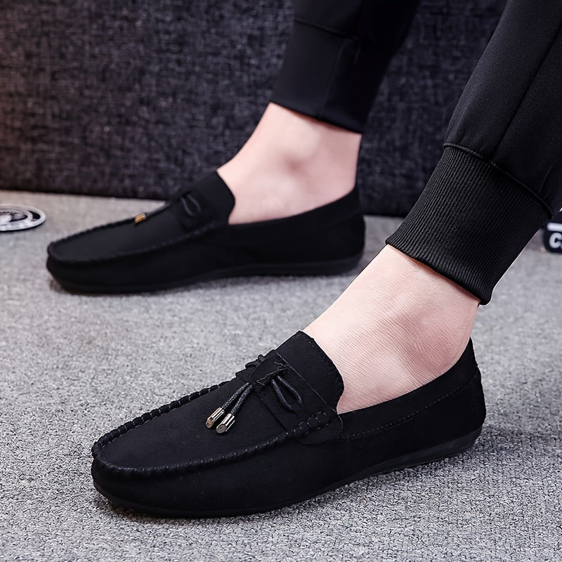 Men's black canvas slip-on loafers with tassel detail, rubber sole, and fabric lining for all seasons. Chic and comfortable canvas shoes.