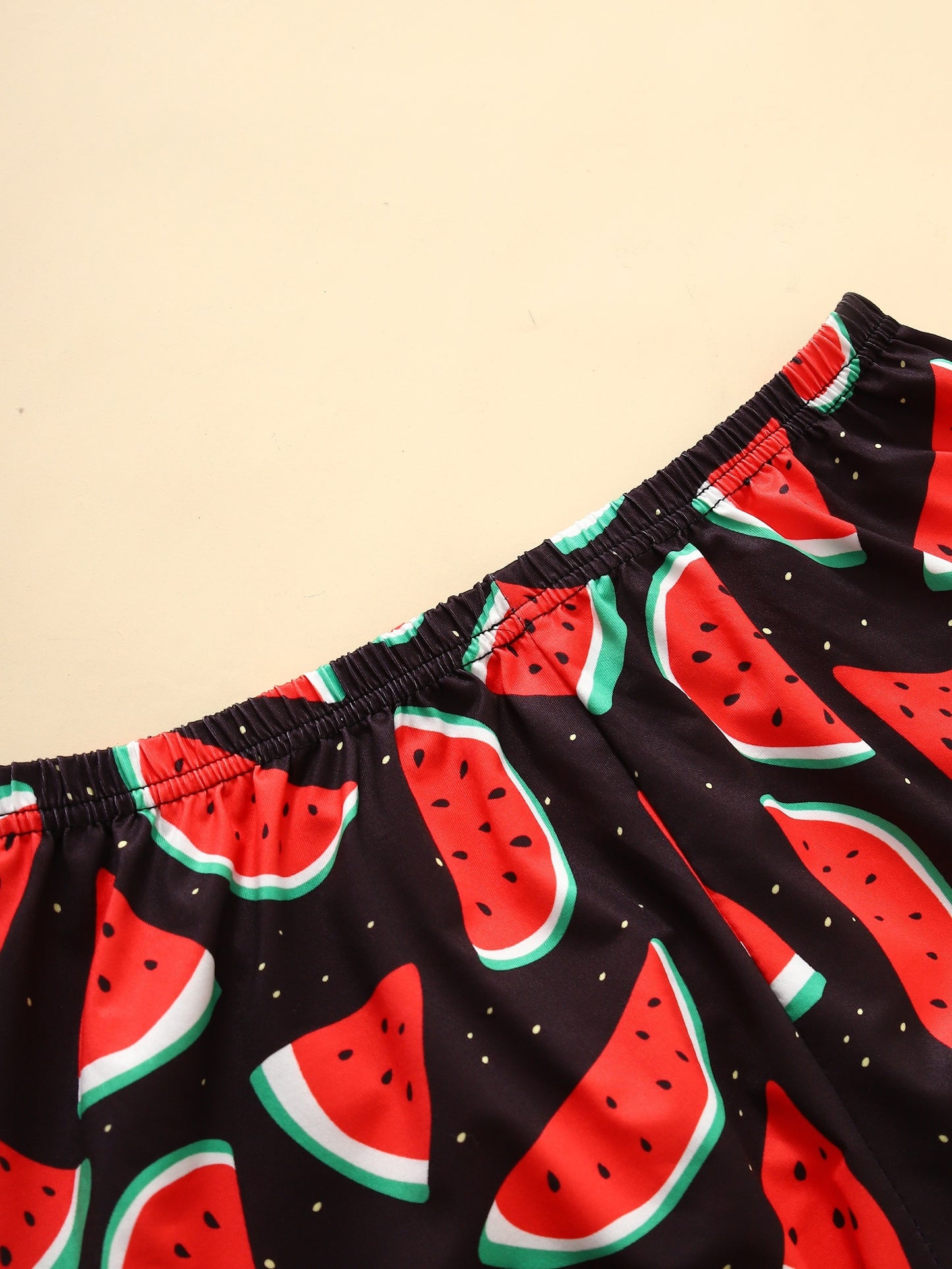 Women's loungewear set with watermelon and letter print, including short sleeve top and elastic shorts.