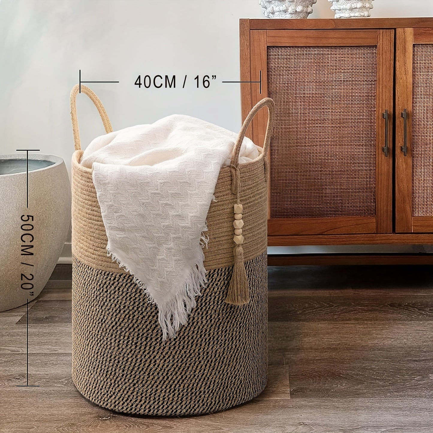 This tall laundry basket measures 40.64cm X 50.8cm and features a woven design with a convenient handle. It can be used as a blanket organizer in the living room, a storage basket for dog toys, or a decorative jute laundry hamper for clothes, pillows