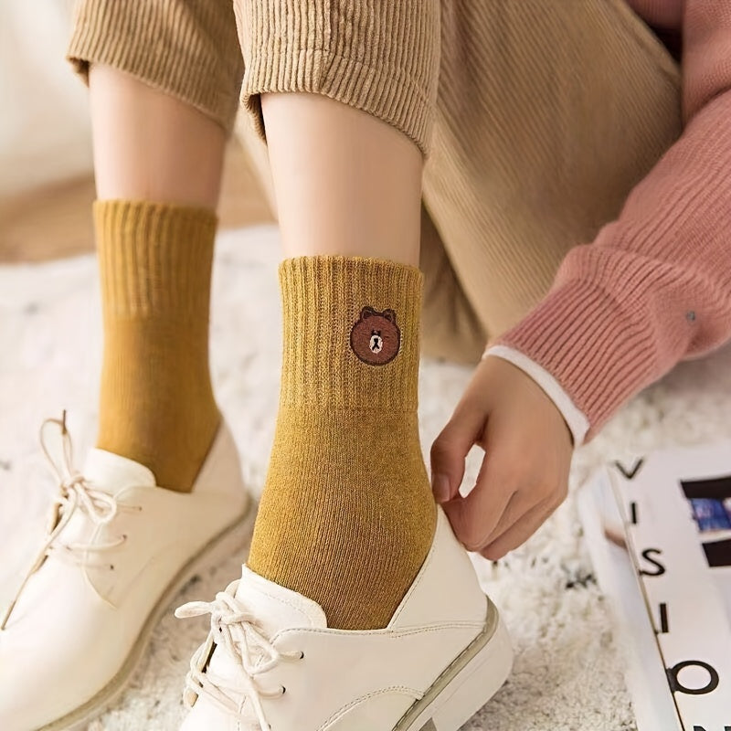 5 pairs of cozy and cute bear-themed mid-calf socks in solid color knitted fabric for warmth in autumn and winter.