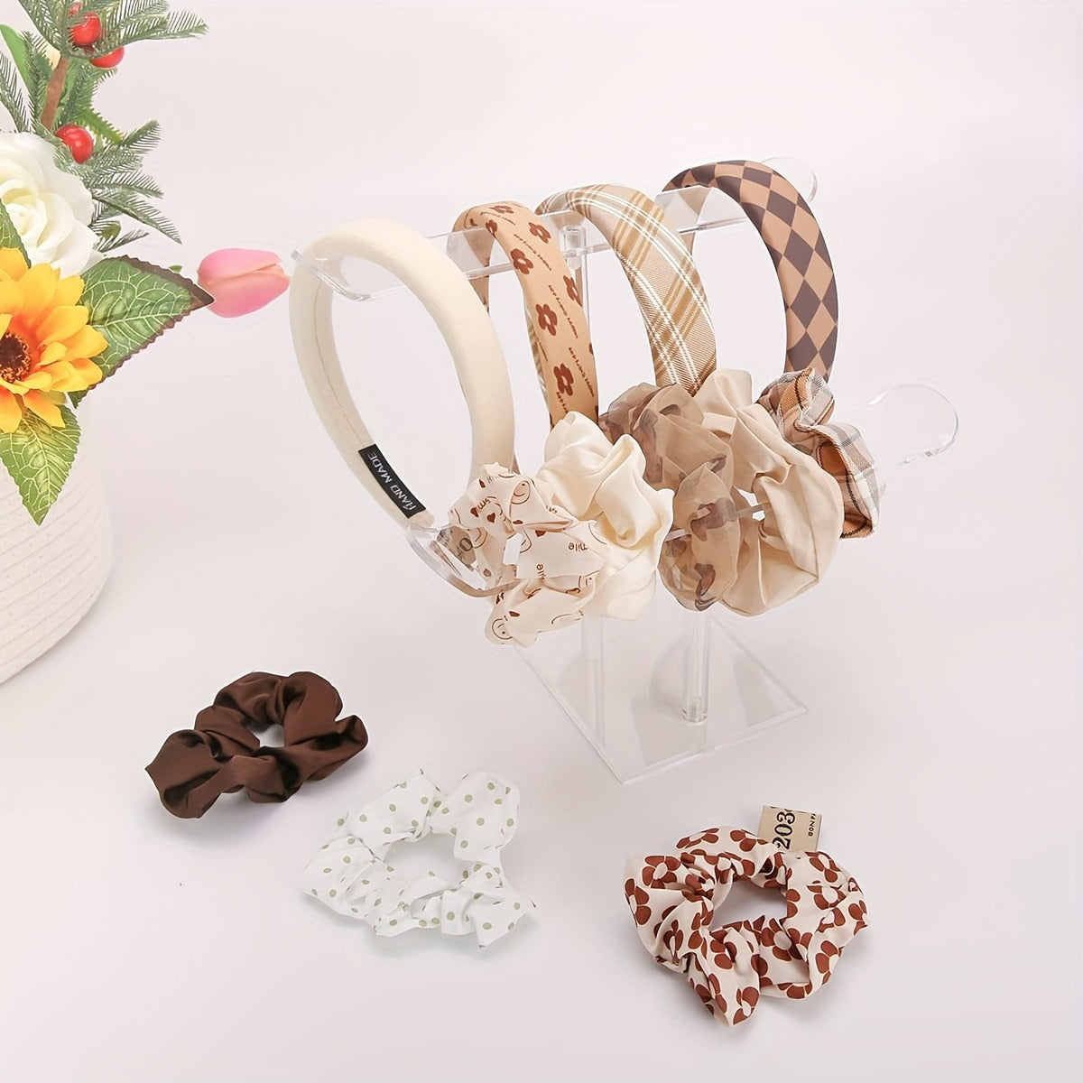 Clear acrylic stand with two tiers for organizing headbands and jewelry. Ideal for displaying hair accessories and bracelets without the need for power. Other accessory organizers also available.