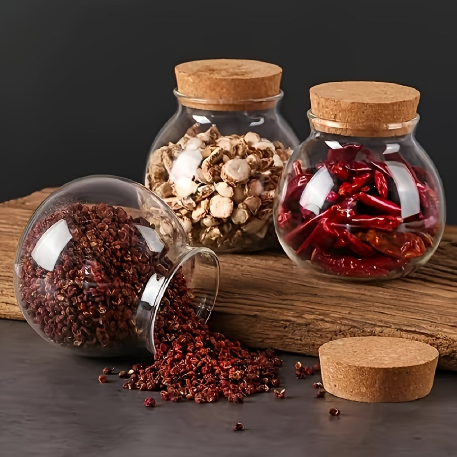 This glass storage jar with cork lid holds 16.9oz and is perfect for storing various items in your kitchen. Made of BPA-free and heat-resistant materials, it is a versatile canister that can be used for storing coffee beans, tea, flour, sugar, and more.