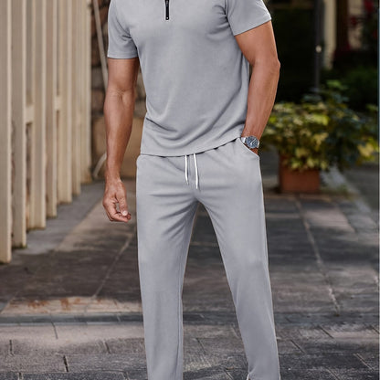 Men's casual outfit: half-zip short sleeve shirt and drawstring pants for outdoor activities.