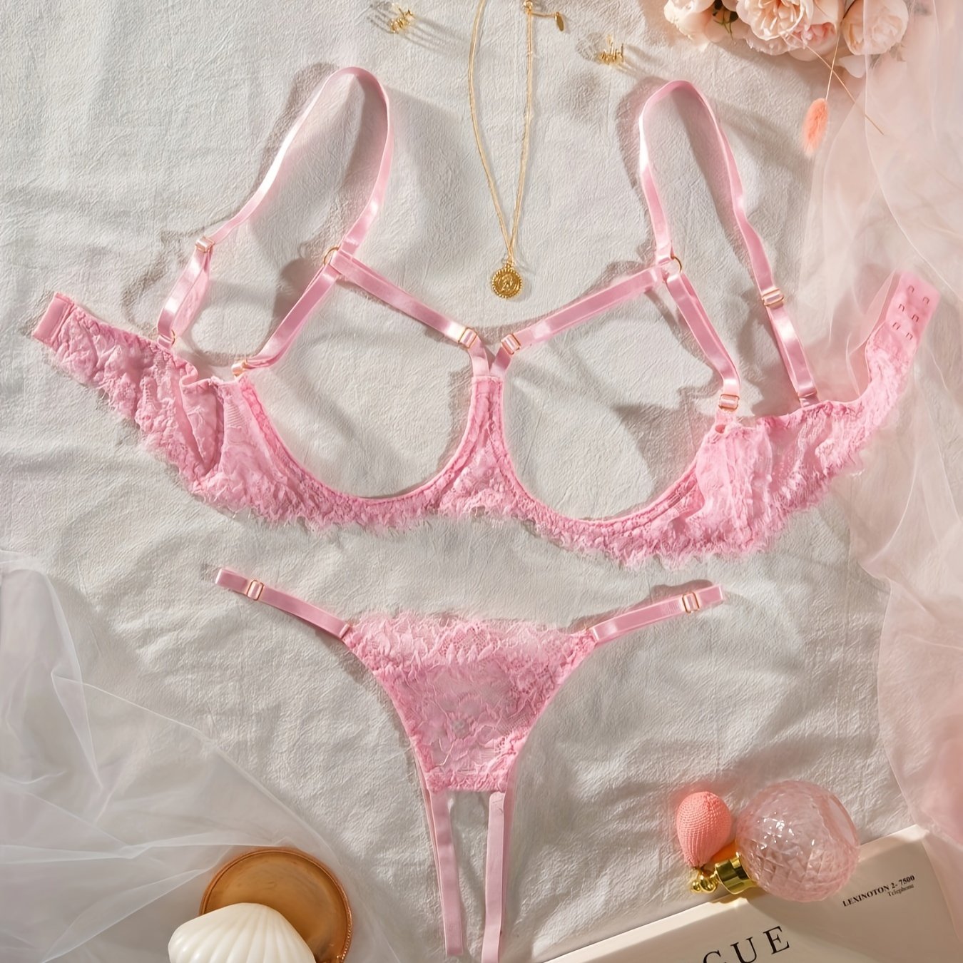 Women's sexy clothing set with open bust bra, open crotch thong, and floral lace design.