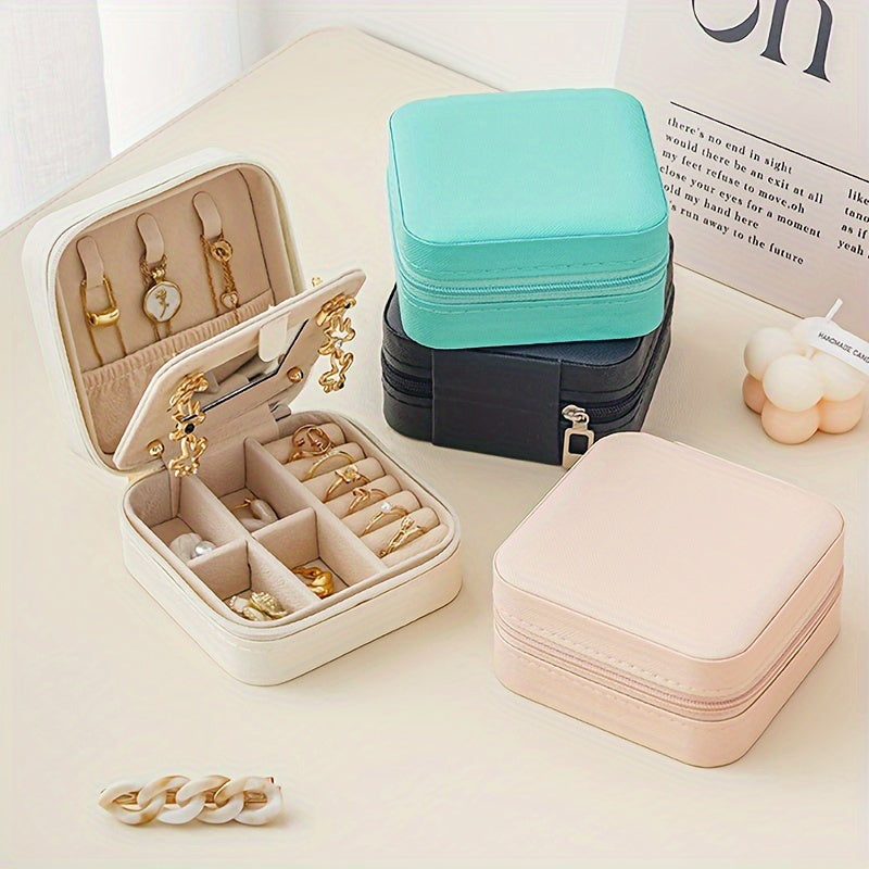 Compact and stylish portable jewelry box with mirror, zipper, and flip cover. Ideal for storing rings, earrings, and necklaces on-the-go.