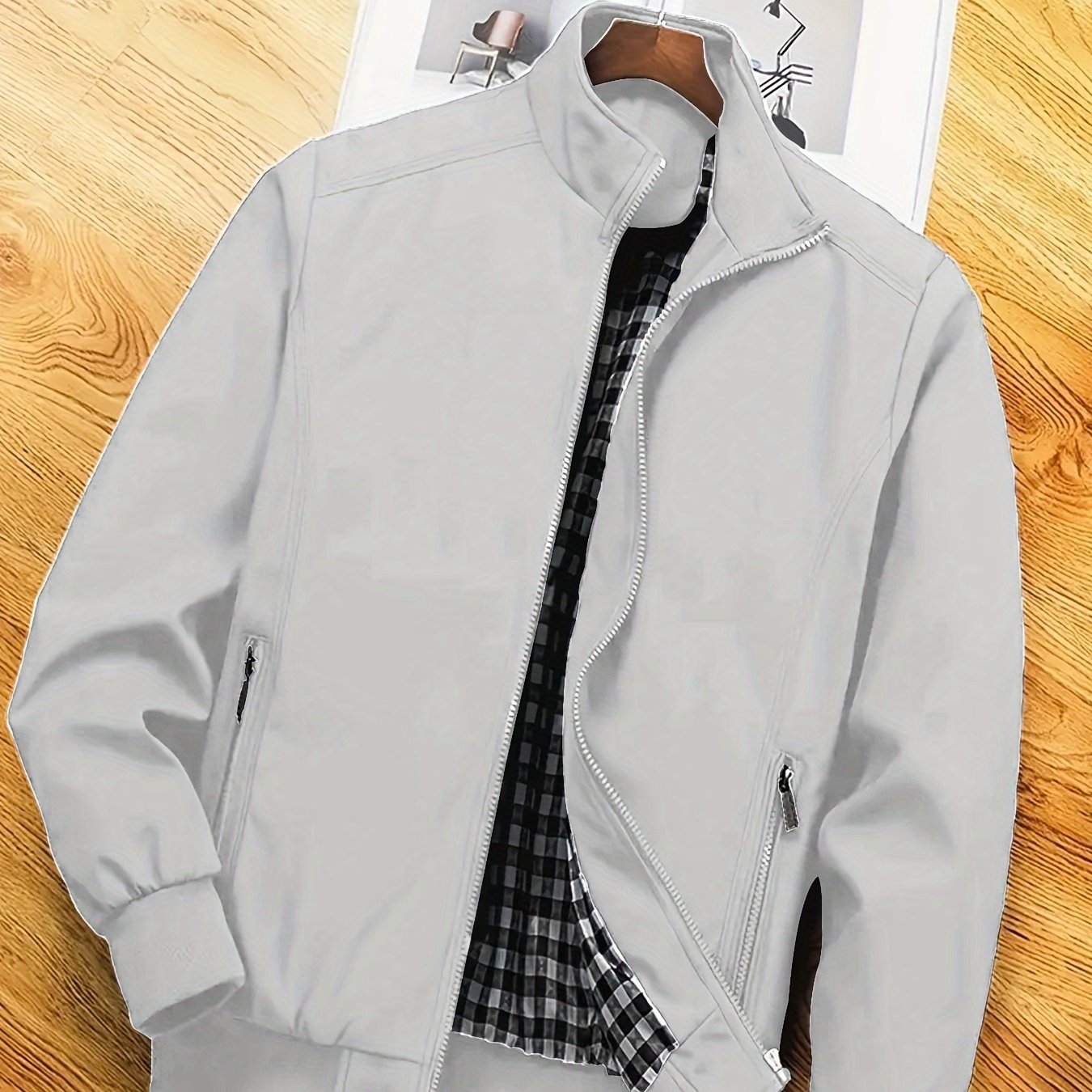 Men's casual spring/autumn polyester jacket with stand collar, zipper pockets, and solid long sleeves for outdoor and workwear.