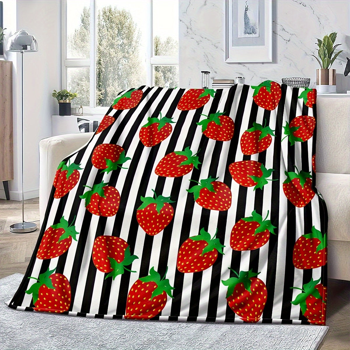 Black striped 1-piece Strawberry Printed Fleece Throw Blanket made from soft microfiber material with a durable twill weave. This all-season blanket features a digital print, is lightweight, and weighs between 250-300g. Perfect for adding a touch of