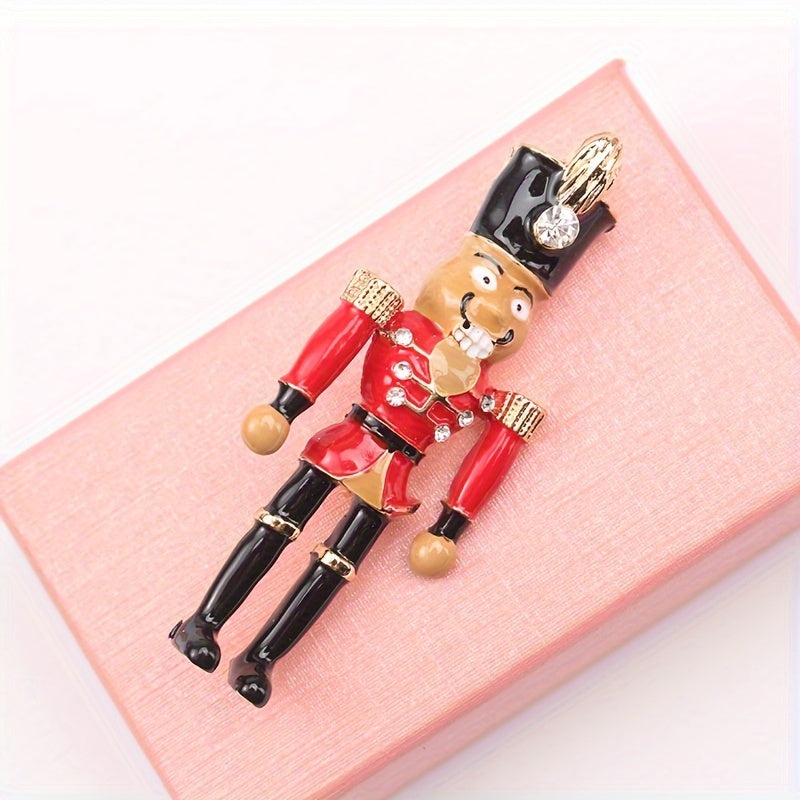 Holiday Nutcracker Soldier Brooch Pin, a festive accessory to adorn your lapel or clothing with a touch of whimsy. Perfect for adding a decorative flair to your outfit.