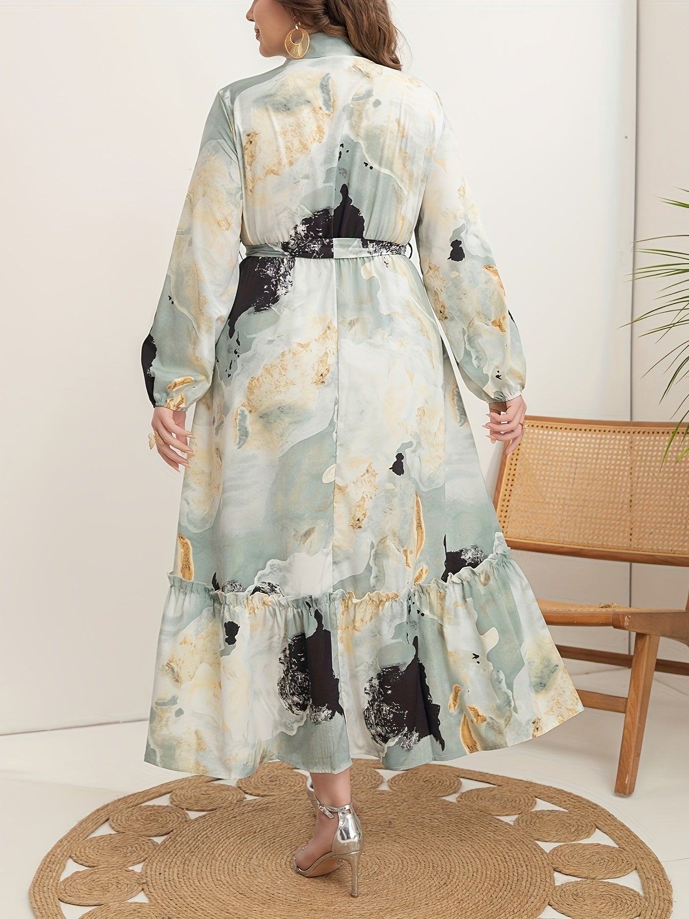 Stylish plus-size marble print dress for women features long sleeves, collar, ruffle hem, and belt. Versatile all-season fashion.