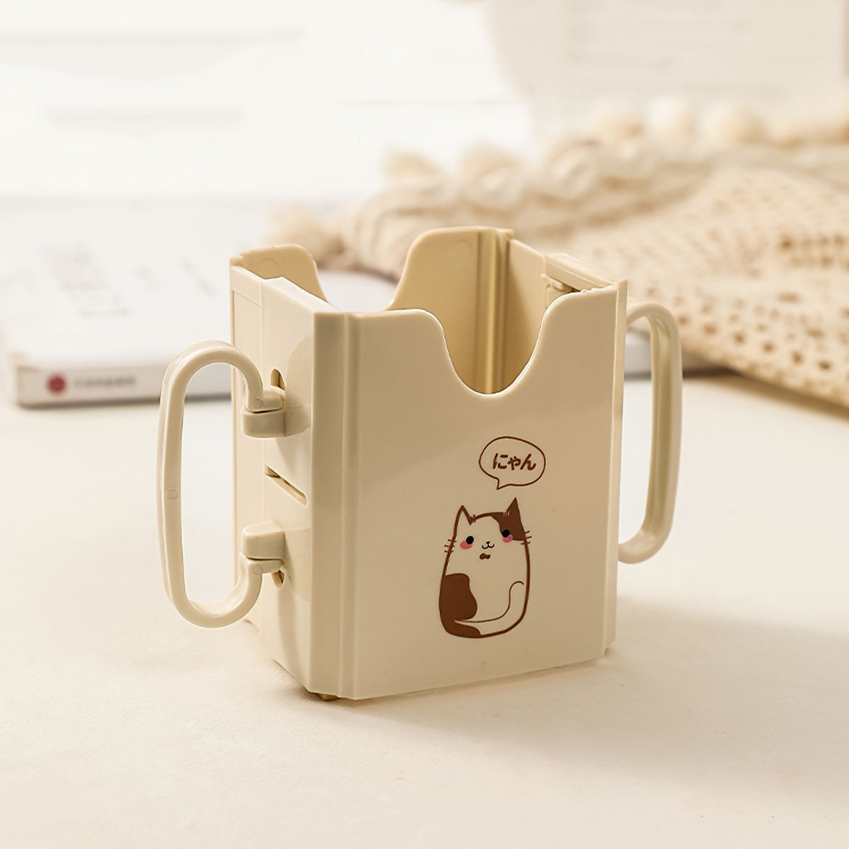 Milk carton holder featuring a cute cat design, made with spill-proof polycarbonate material. This drink support bracket is food contact safe and keeps beverages upright.