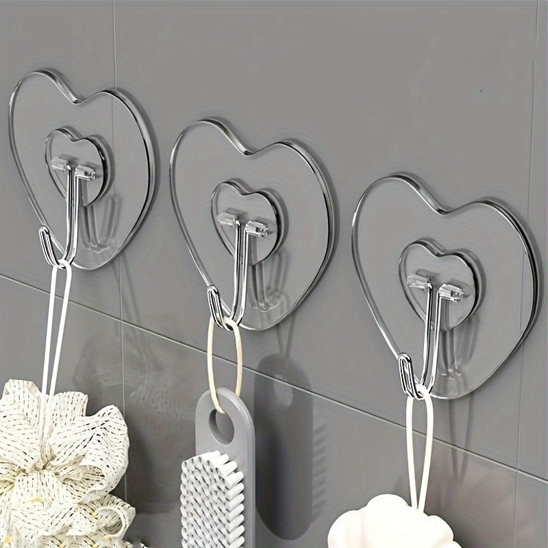 10-pack of heavy-duty adhesive hooks with clear plastic suction cups, heart-shaped wall mounts for kitchen and bathroom storage. Easy to install and perfect for casual style utility hooks.