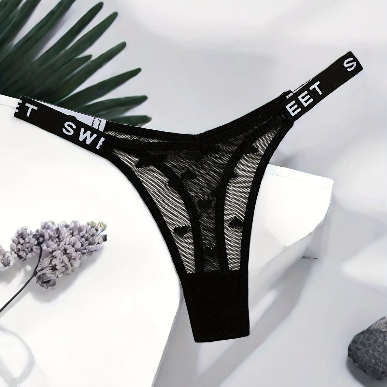 Stylish polyamide blend thong underwear with heart pattern, mesh design, and comfortable stretch fit.