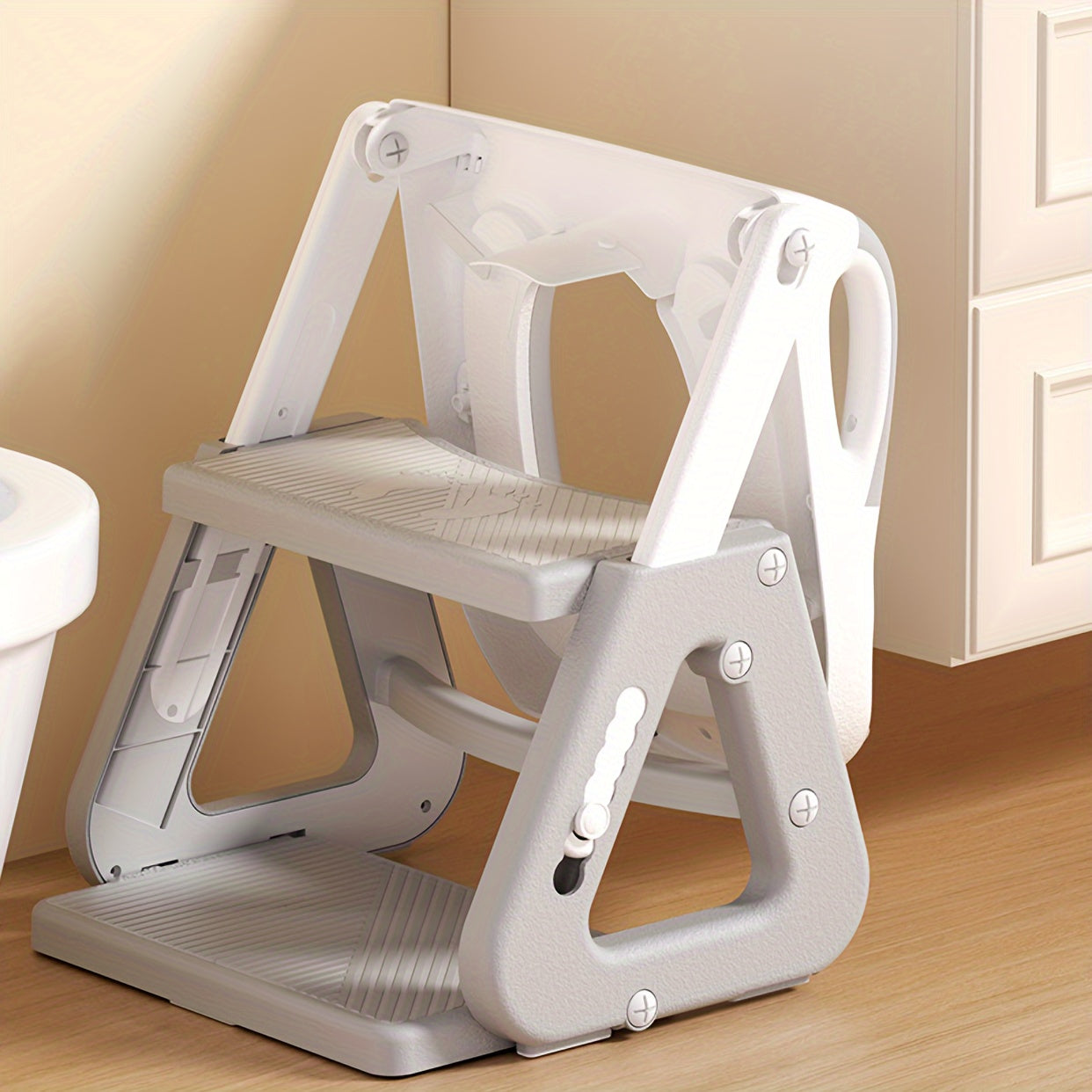 Versatile toilet training ladder for children, doubling as a folding footstool for the toilet, with a detachable toilet ring for added convenience.