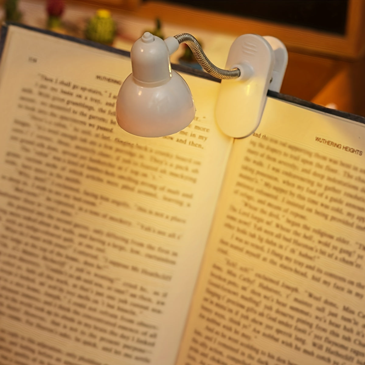 Mini clip-on reading lamp with push button control, adjustable arm, and fantasy-themed brushed finish made of plastic material. Battery operated for bedroom tabletop use as a night light.