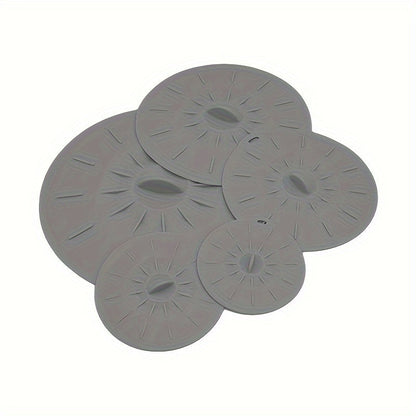 A collection of 5 durable silicone lids that are perfect for covering bowls, cups, plates, pots, pans, and more. These versatile covers can be used in the microwave, stovetop, oven, fridge, and freezer. They are BPA-free and come in various sizes to suit