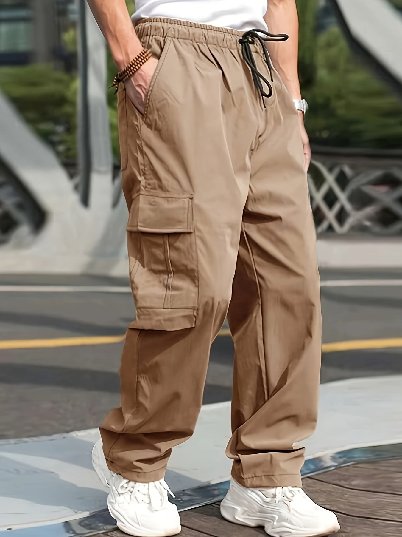 Men's olive green cargo pants with side pockets, adjustable waist, and lightweight twill fabric - perfect for casual street style jogging in all seasons.