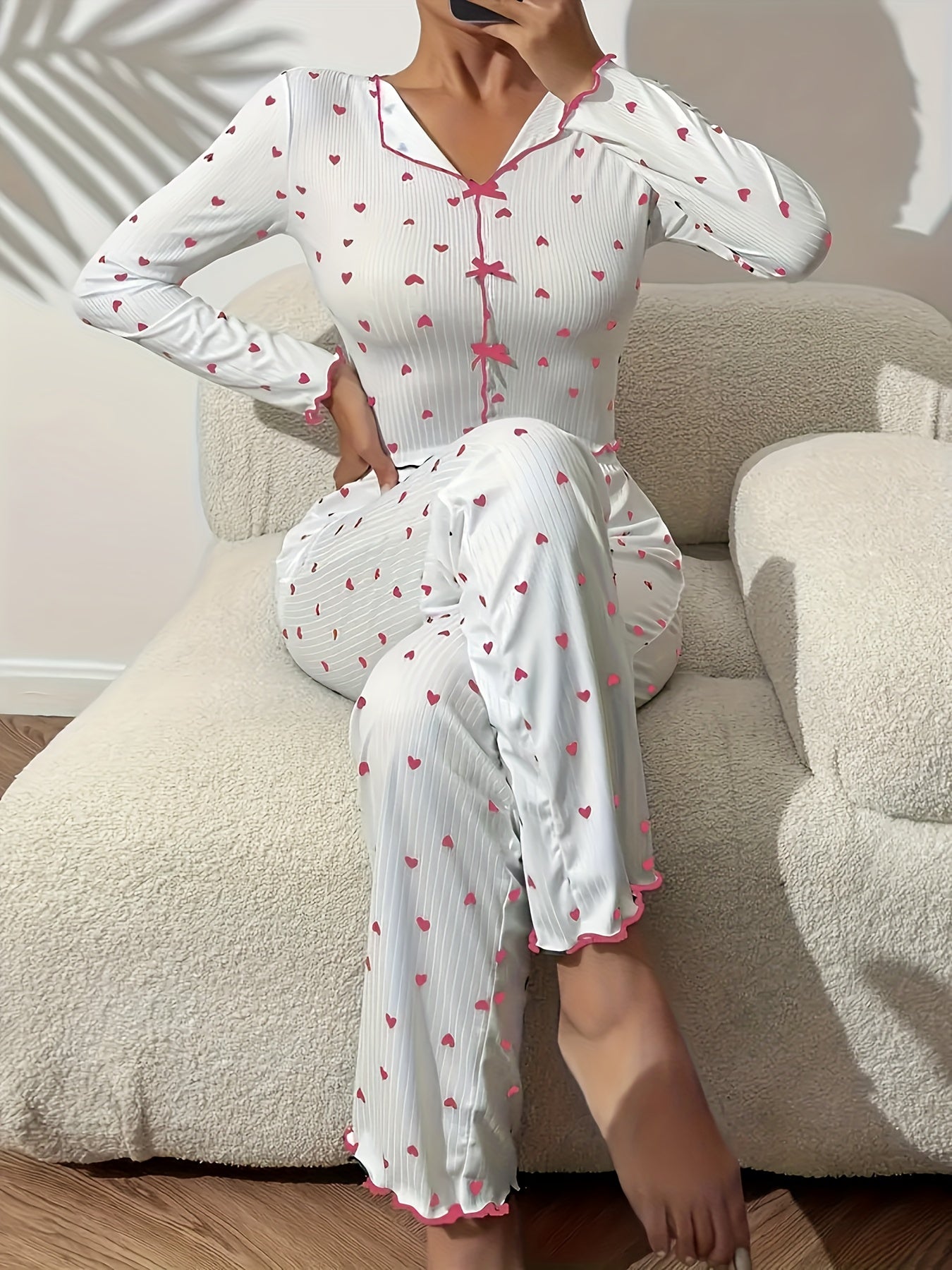 Heart print lounge set with frill trim and bow detail, featuring a V-neck crop top and pants for a comfortable and relaxed fit in the fall.